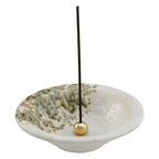 incense stick in white ceramic holder