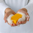 Hands holding a persimmon soap