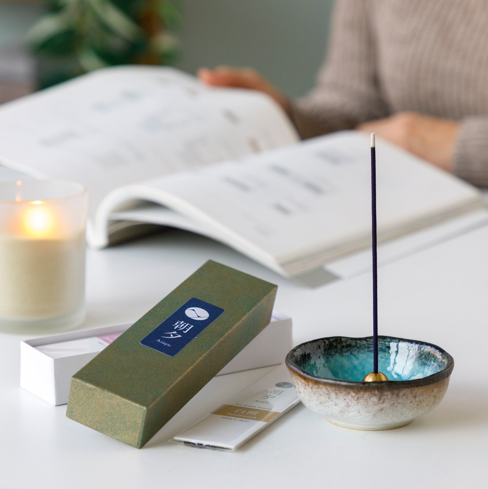 Sandalwood incense sticks variety pack with incense holder next to a candle