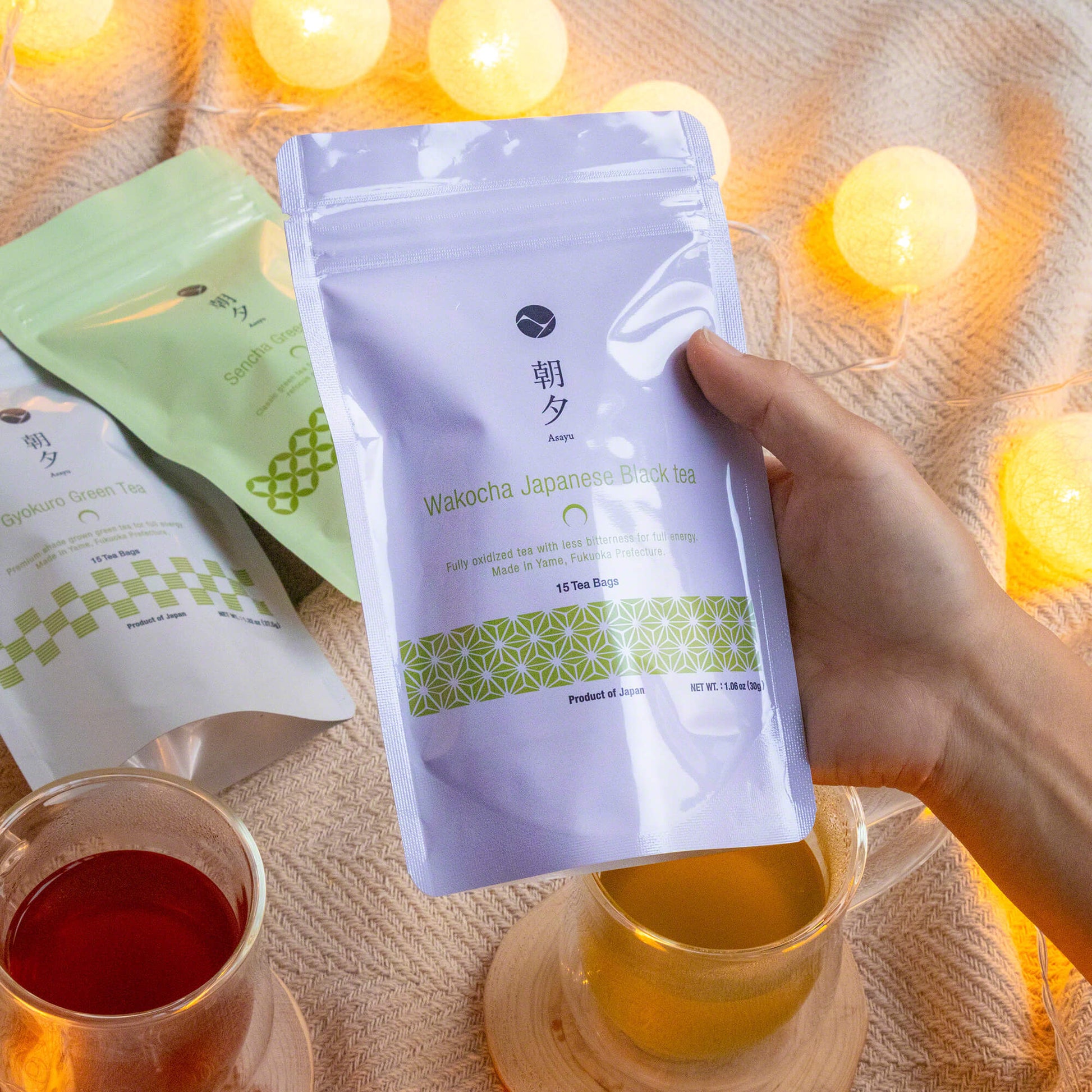 hand holding a pouch of asayu wakocha tea bags