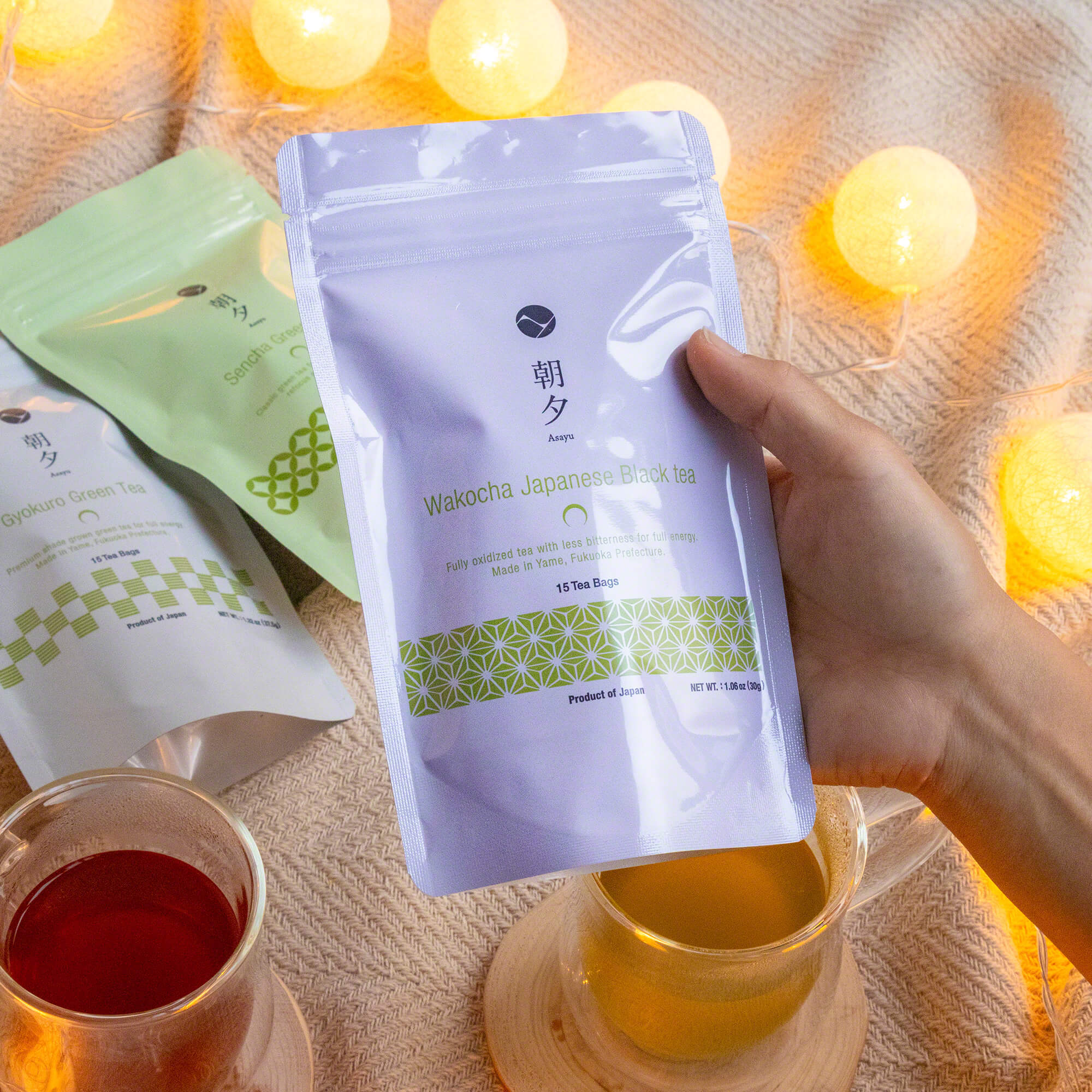 hand holding a pouch of asayu wakocha tea bags