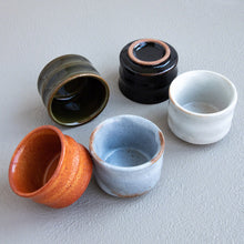 Cargar imagen en el visor de la galería, 5 different colored ochoko sake cups spread out on a table
