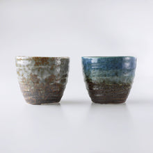Lade das Bild in den Galerie-Viewer, A view from the side of Handpainted Glazed Ceramic Tea Cups Set of 2 in Blue and White by Asayu Japan.
