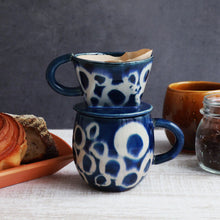 Lade das Bild in den Galerie-Viewer, The Asayu Japan Coffee Mug in ocean blue with white abstract pattern with the matching coffee dripper and with a paper filter on it.
