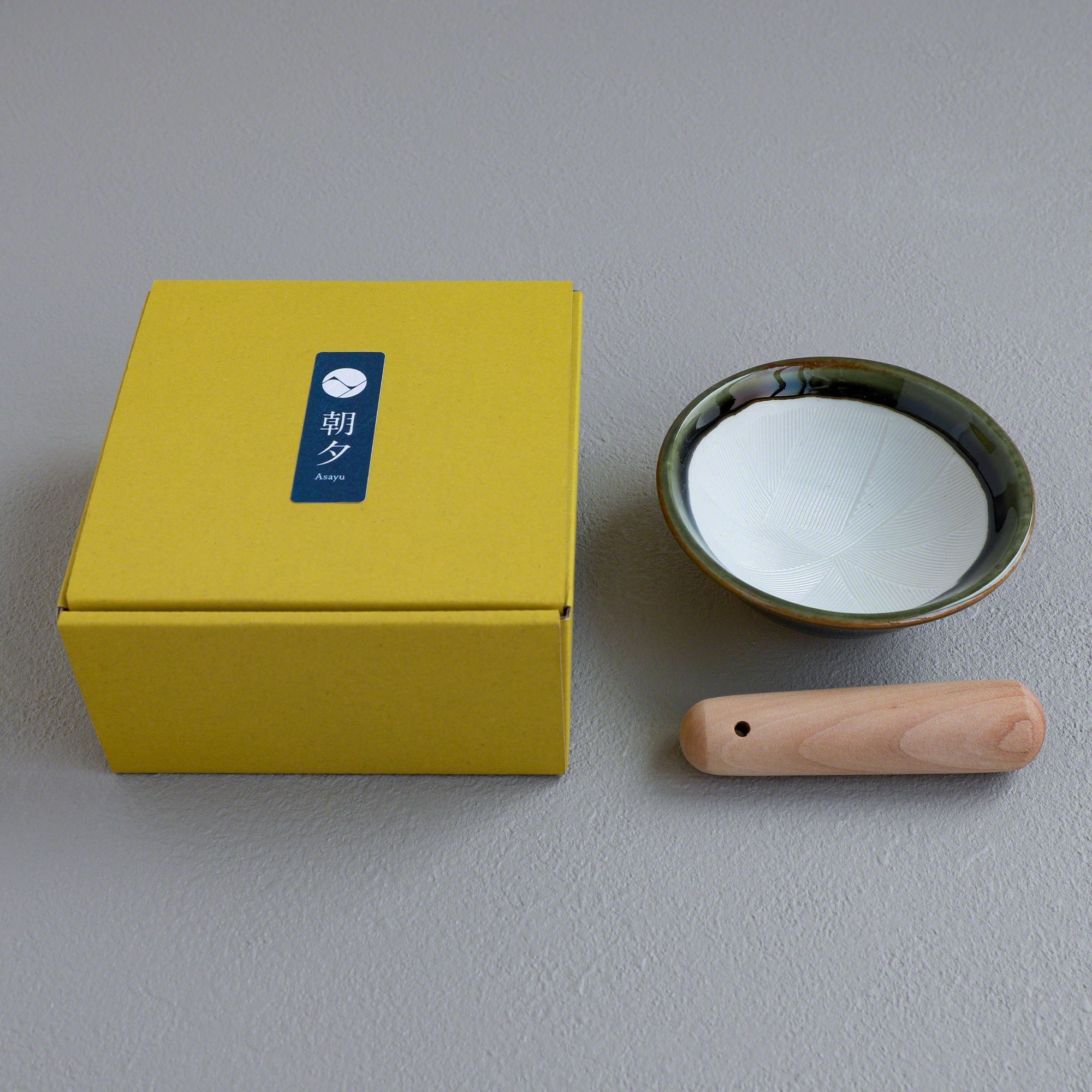Picture of the Ceramic Olive Green Mortar Bowl and Pestle Set with the packaging box with the Asayu Japan logo.