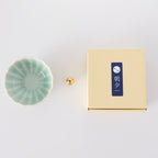 Asayu Japan Turquoise Mini Lotus Flower Incense Plate next to the included brass incense stand and the packaging box.