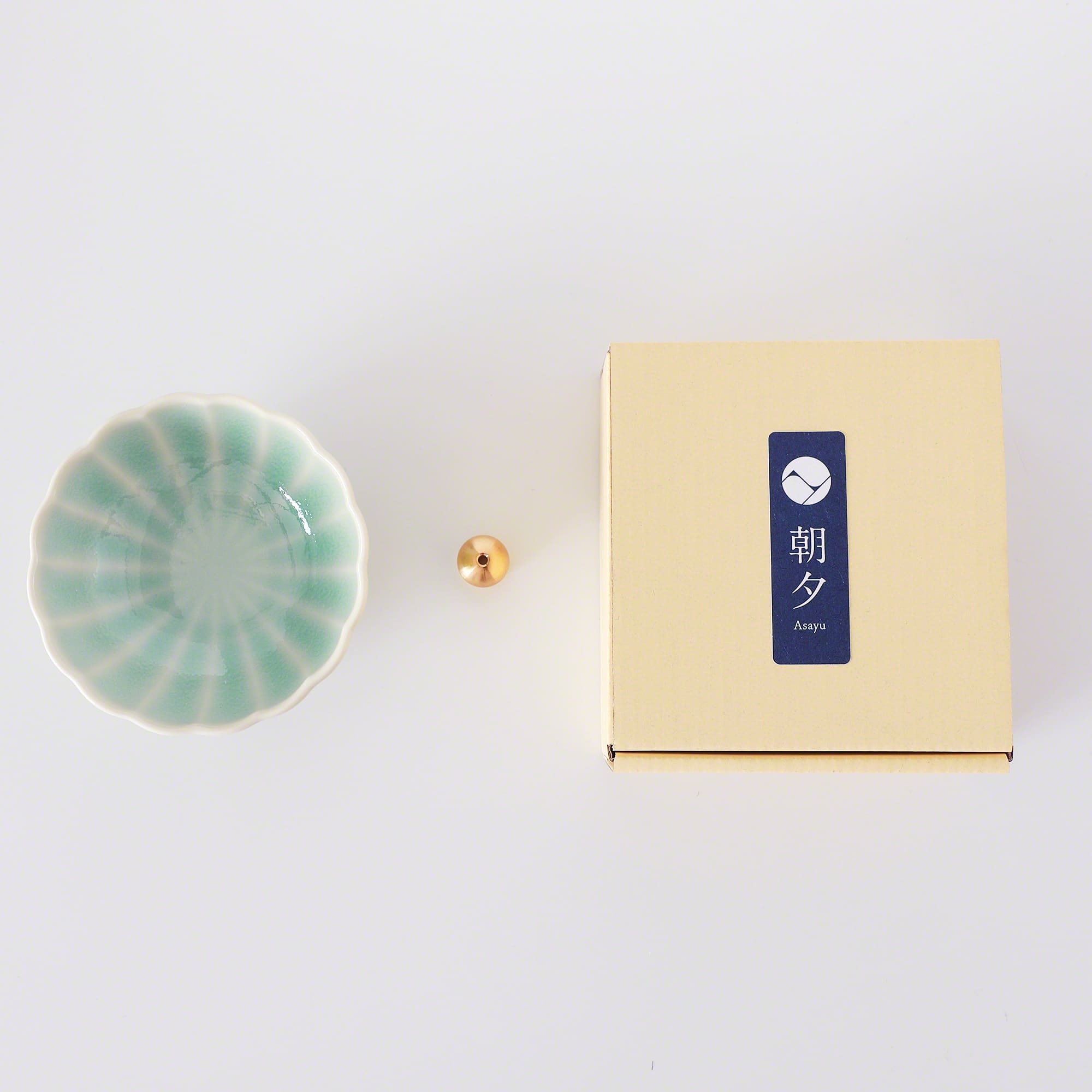 Asayu Japan Turquoise Mini Lotus Flower Incense Plate next to the included brass incense stand and the packaging box.