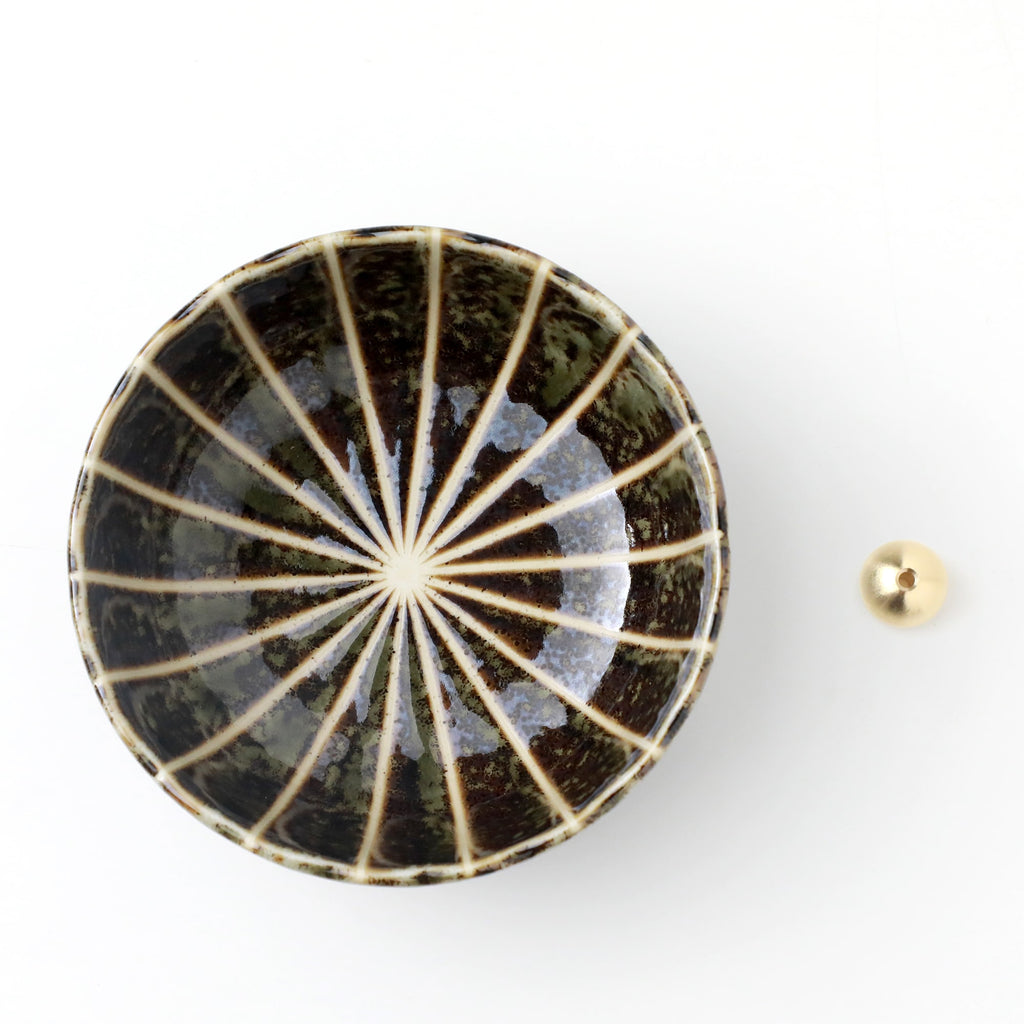 Asayu Japan dark green lotus flower ceramic incense plate with included brass incense burner stand next to it from the top.