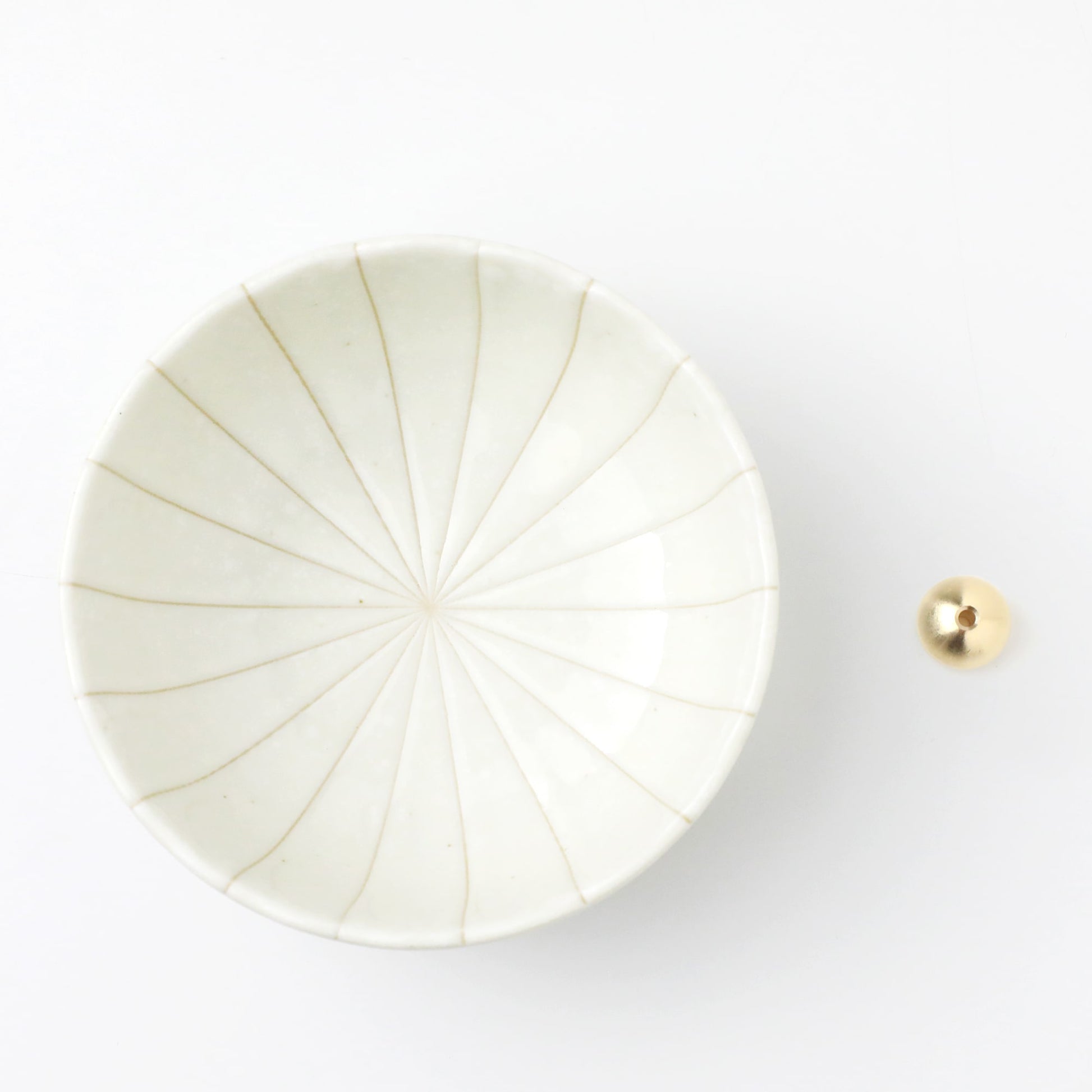 Asayu Japan white lotus flower ceramic incense plate with included brass incense burner stand next to it from the top.