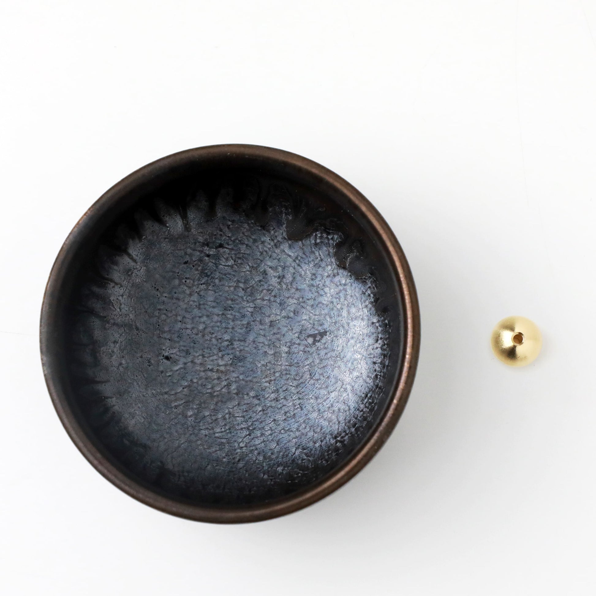 Asayu Japan Zen ceramic incense plate with included brass incense burner stand next to it from the top.