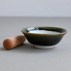 Asayu Japan Ceramic Olive Green Mortar Bowl and Wooden Pestle seen from the side.