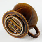 Bottom of the Asayu Japan Ceramic Coffee Dripper in Caramel with the 3 filter holes.