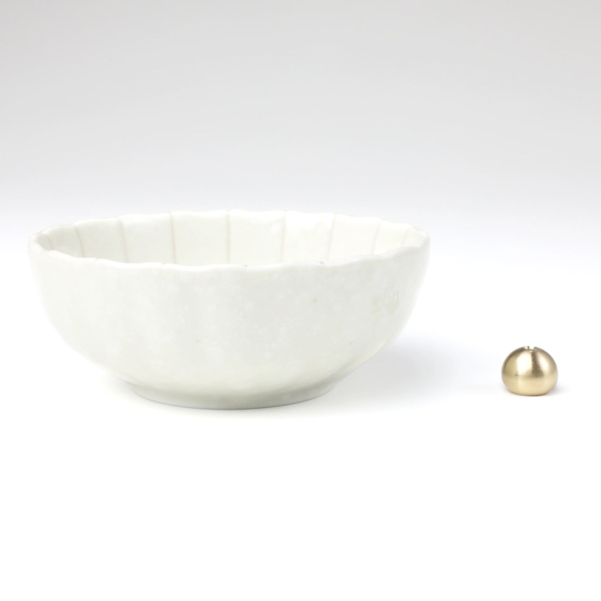 Asayu Japan white lotus flower ceramic incense plate with included brass incense burner stand next to it from the side.