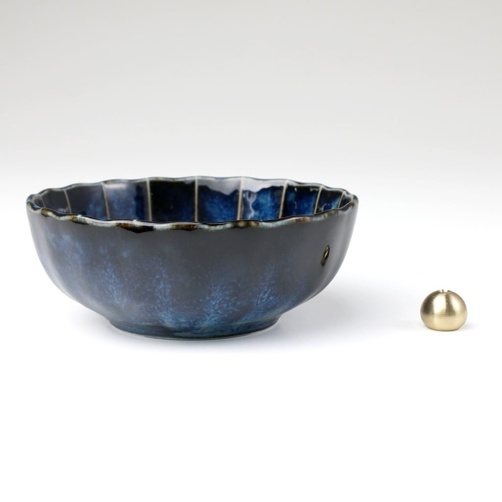 Asayu Japan dark navy blue lotus flower ceramic incense plate with included brass incense burner stand next to it from the side.