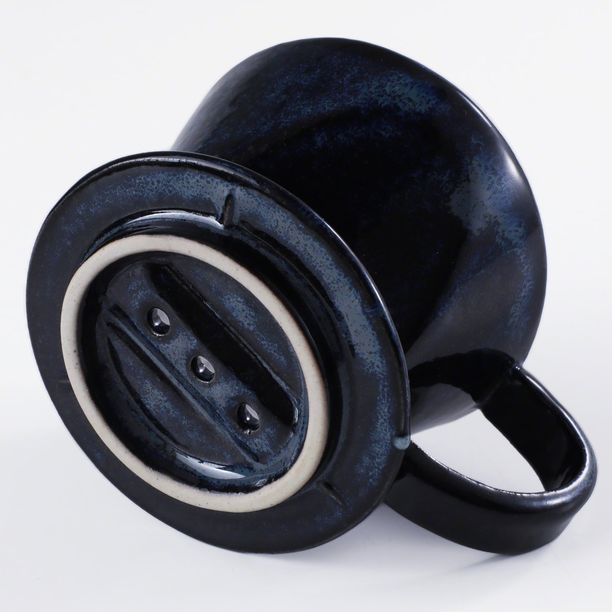 Bottom of the Asayu Japan Ceramic Coffee Dripper in dark navy blue with the 3 filter holes.