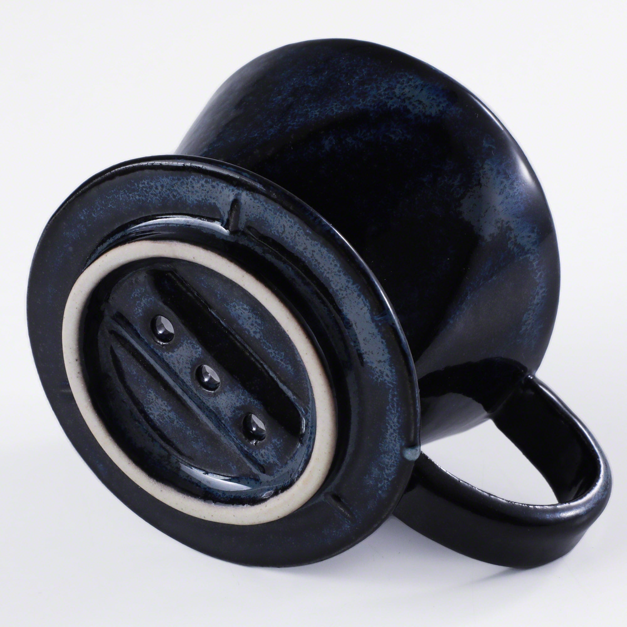 Bottom of the Asayu Japan Ceramic Coffee Dripper in dark navy blue with the 3 filter holes.