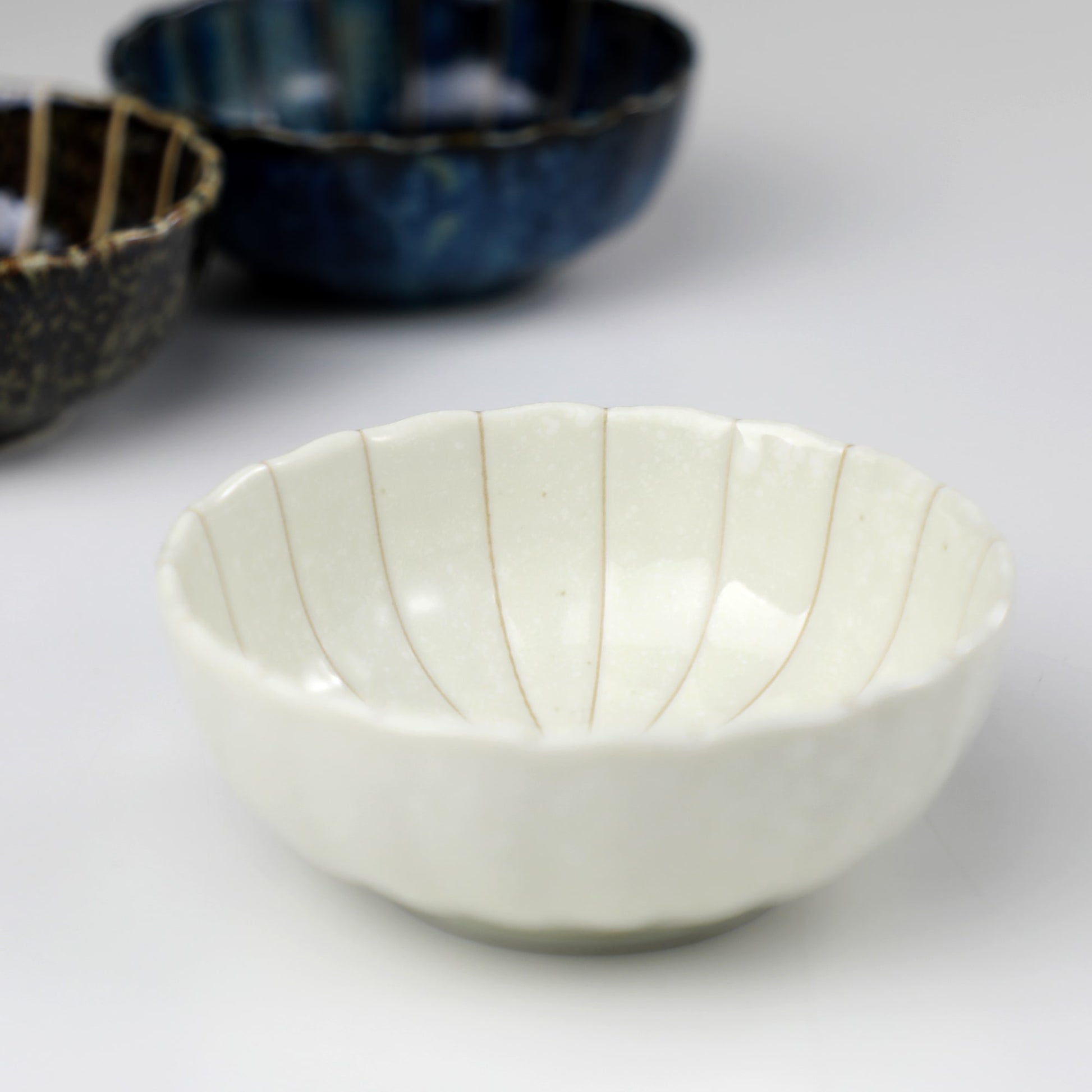 White Lotus incense holder by Asayu Japan in front of the rest of the Lotus Flower shaped incense holder collection