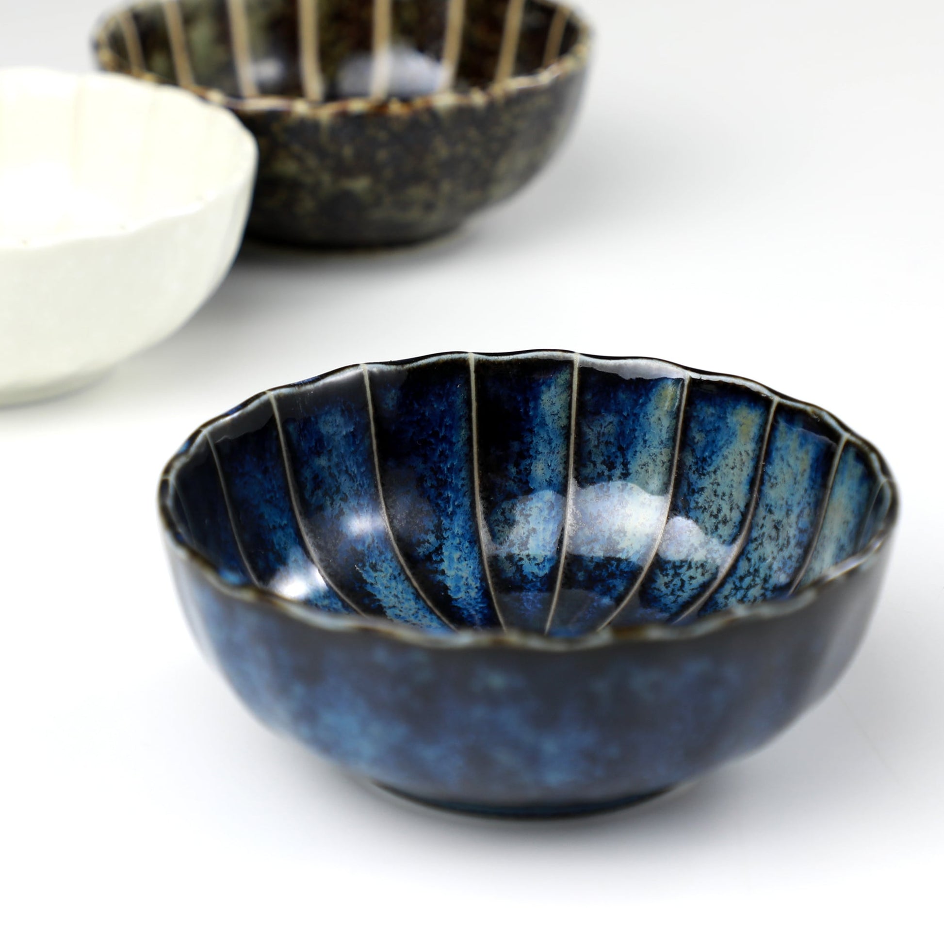 Dark Navy Blue Lotus incense holder by Asayu Japan in front of the rest of the Lotus Flower shaped incense holder collection