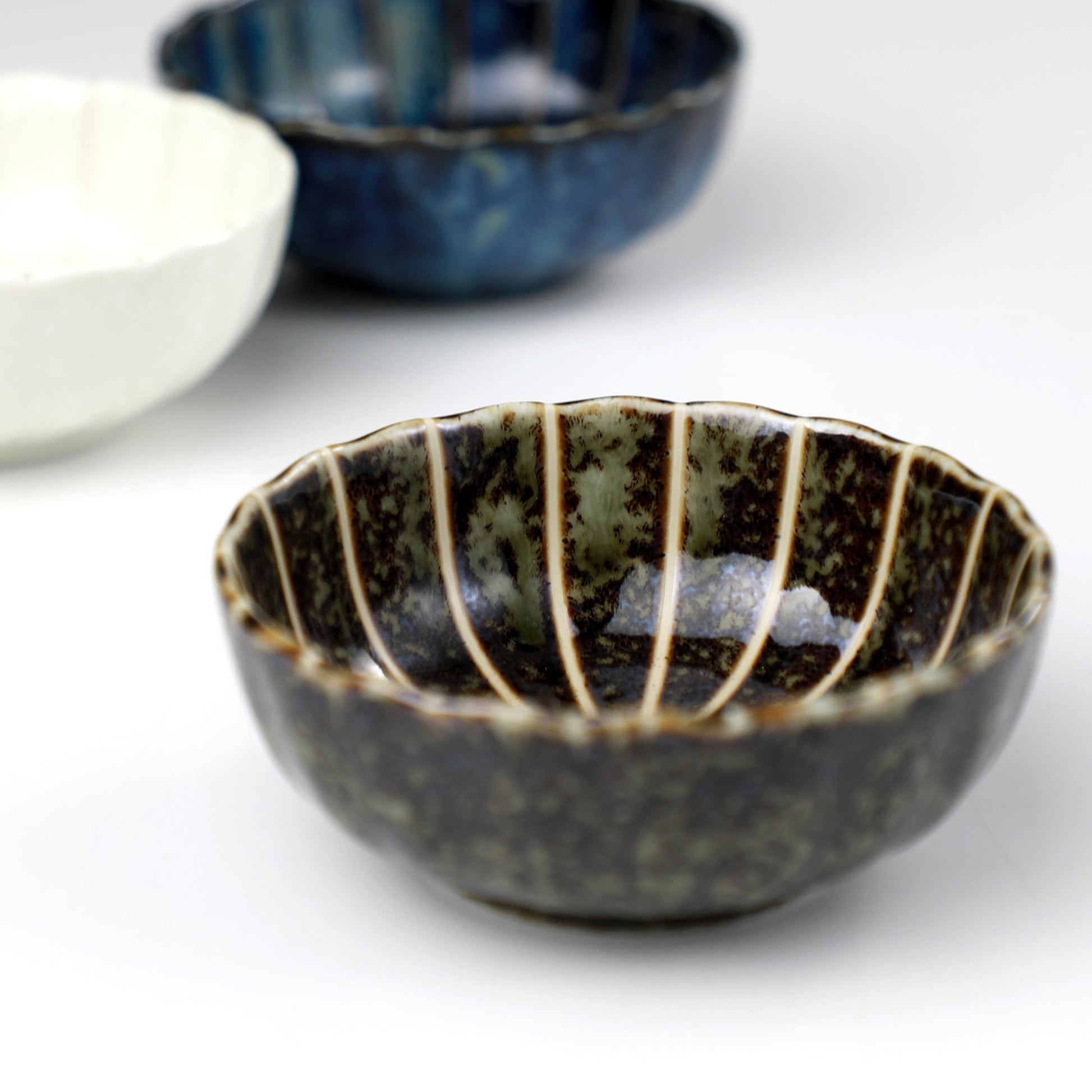 Dark Green Lotus incense holder by Asayu Japan in front of the rest of the Lotus Flower shaped incense holder collection