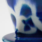 Close-up of the glaze in the Asayu Japan Ceramic Coffee Dripper Ocean model in blue with abstract white pattern.