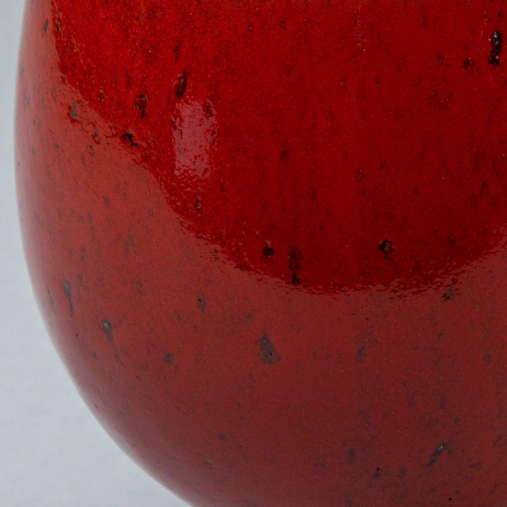Close-up of the glaze in the Asayu Japan Ceramic Coffee Mug in chrome red.