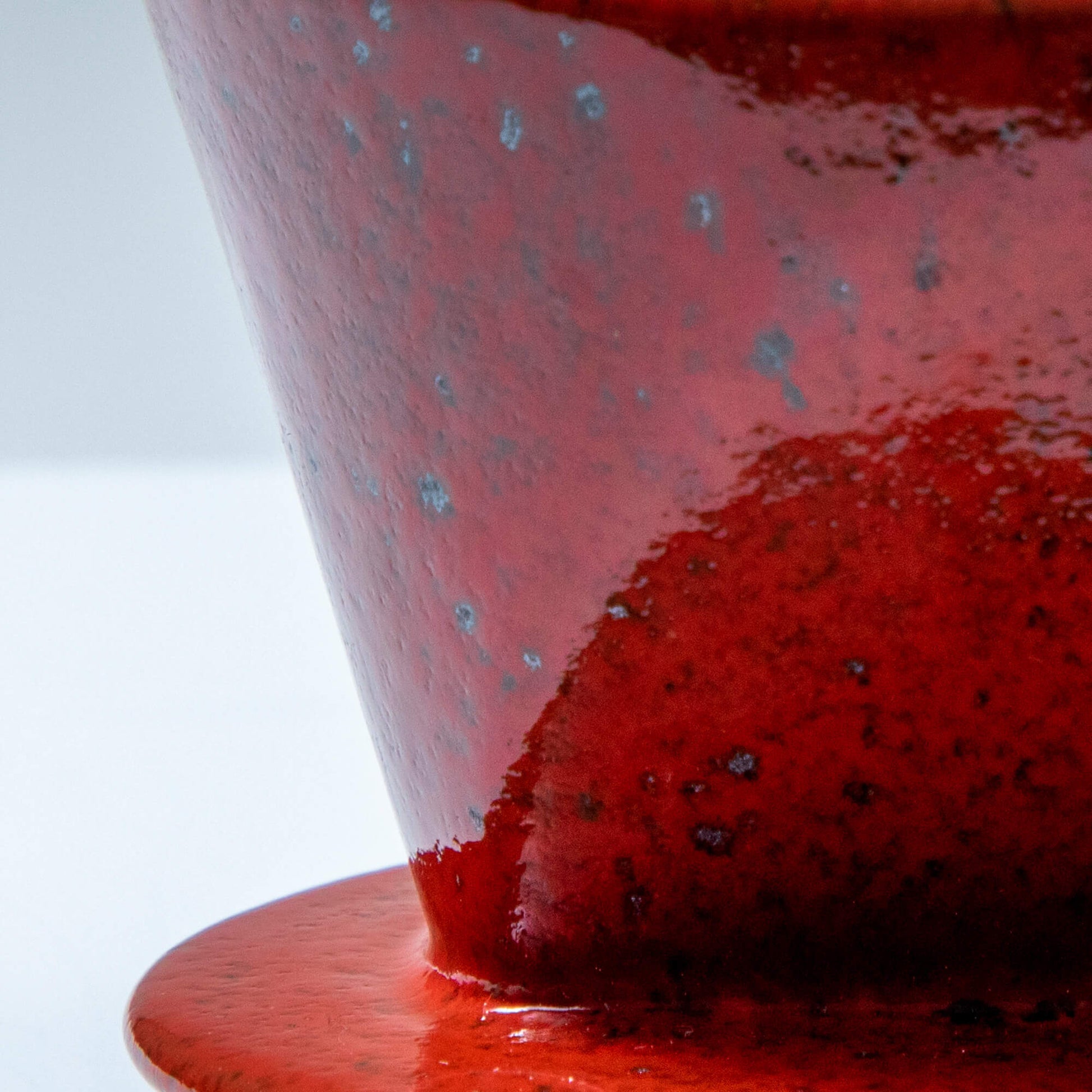 Close-up of the glaze in the Asayu Japan Ceramic Coffee Dripper in chrome red.
