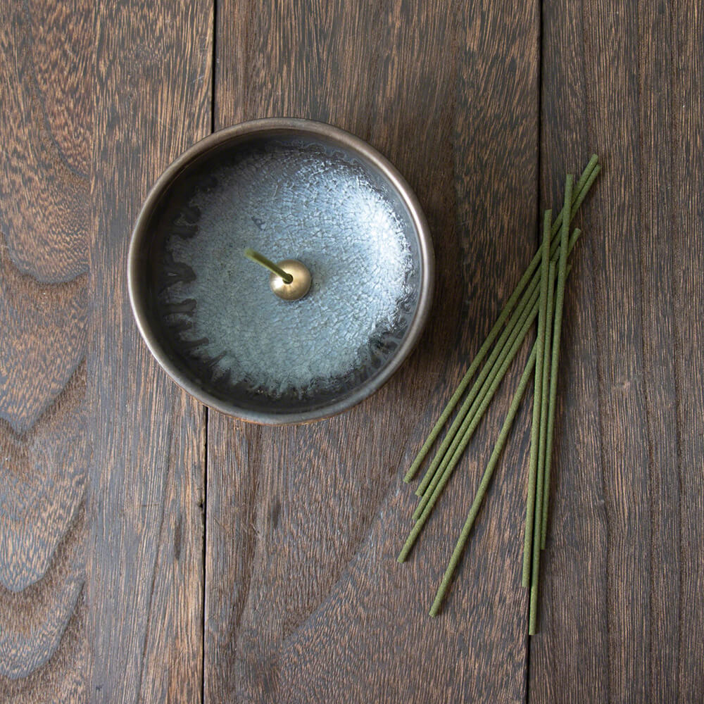 Asayu Japan Zen Incense Holder with brass stand next to incense sticks on a wooden table