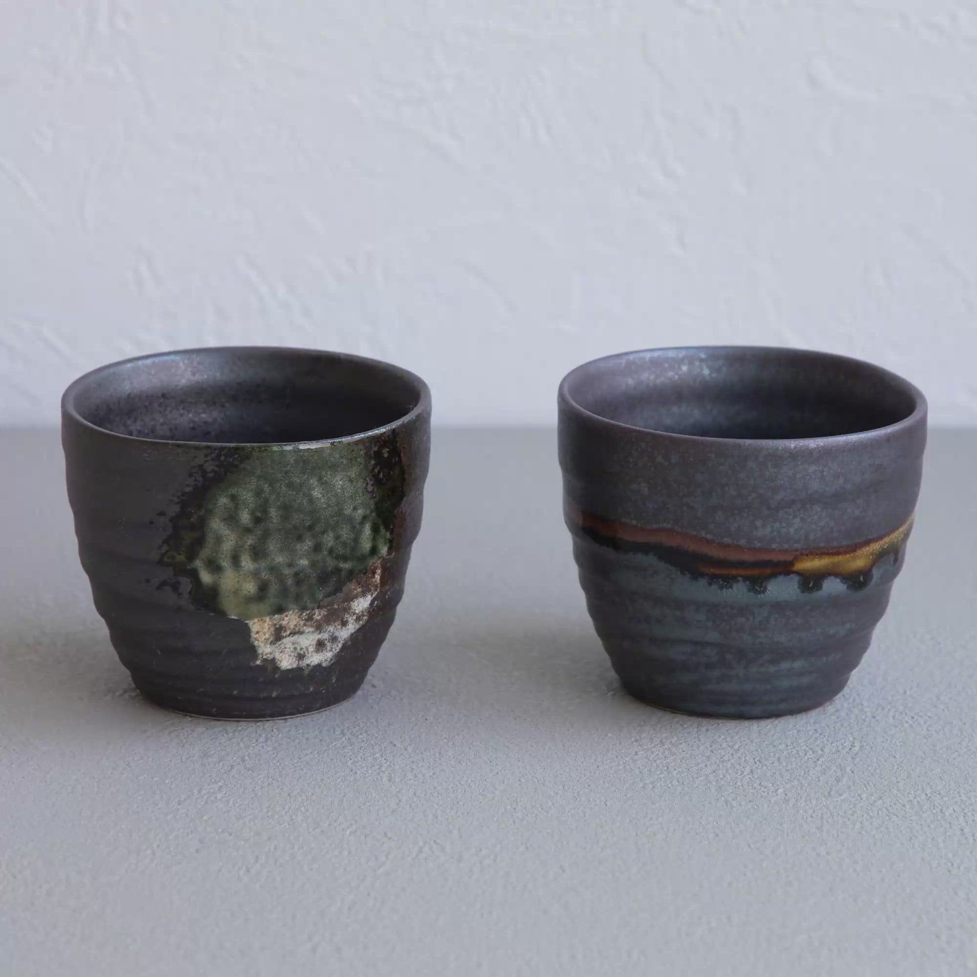 Video showing the Asayu Japan Handpainted Glazed Ceramic Tea Cups Set of 2 in Dark Metallic Brown.