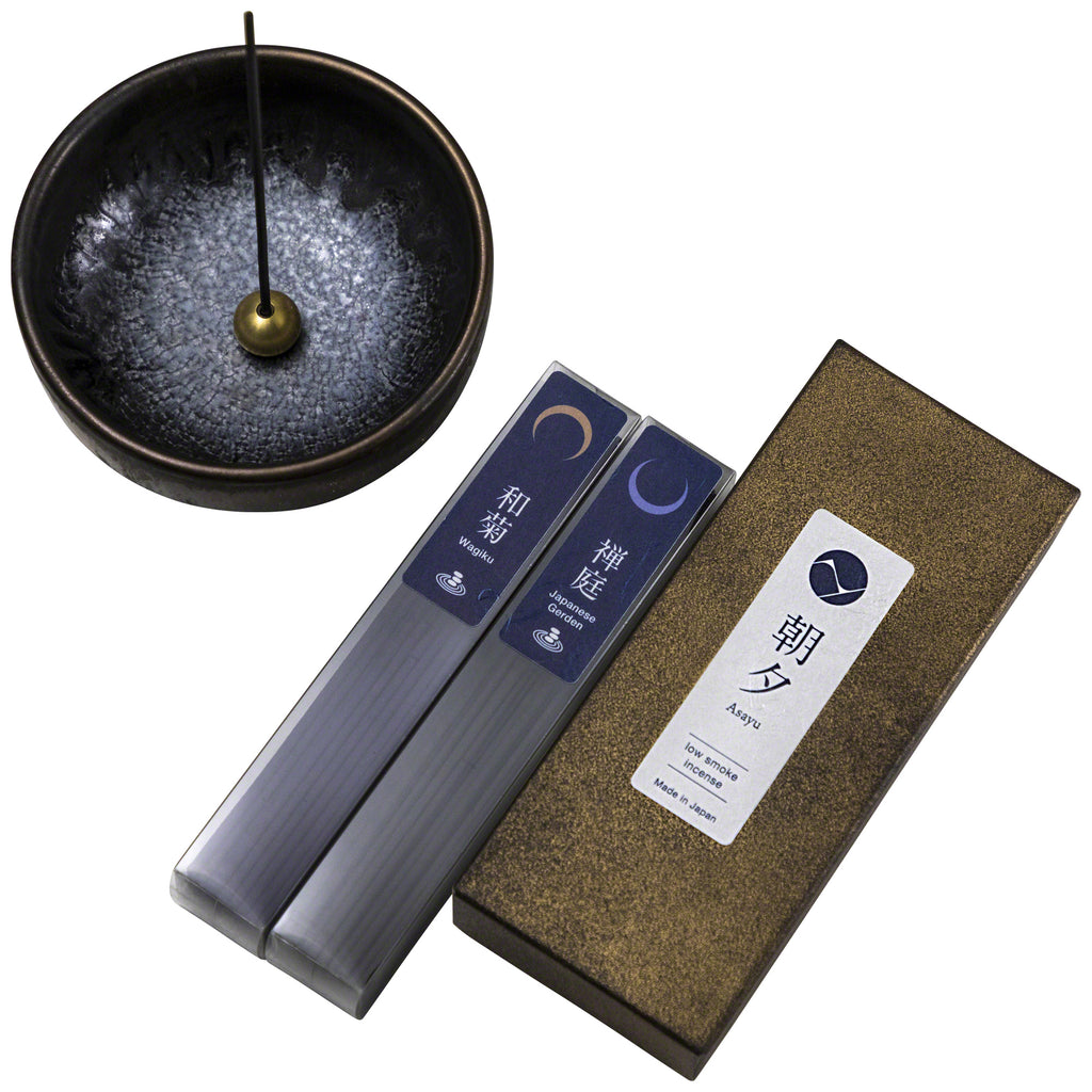 Ceramic zen incense holder next to zen incense sticks set