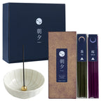 Japan incense sticks set next to white lotus holder in front of blue gift box