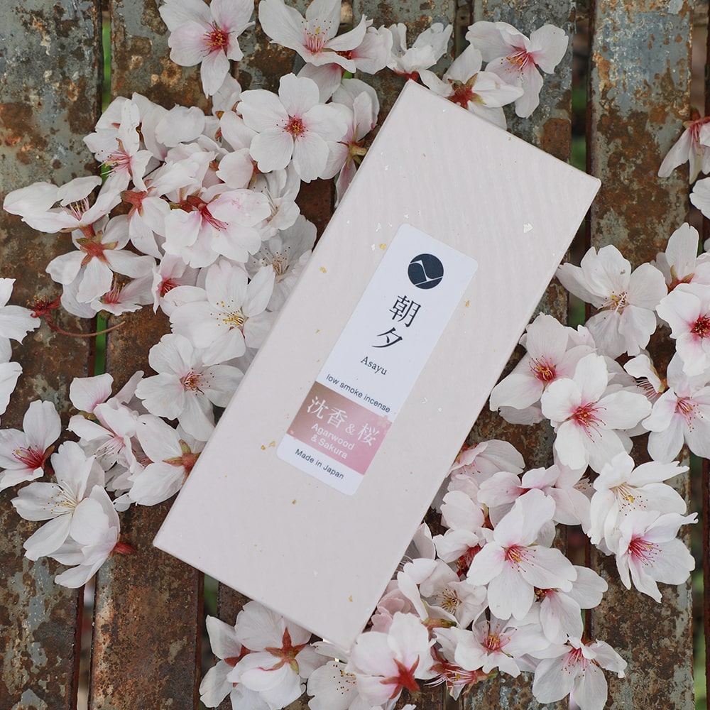 Premium Sakura Cherry Blossom and Agarwood Blend Low Smoke Incense Sticks by Asayu Japan surrounded by sakura petals