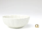 Asayu Japan white lotus flower ceramic incense plate with included brass incense burner stand next to it from the side.
